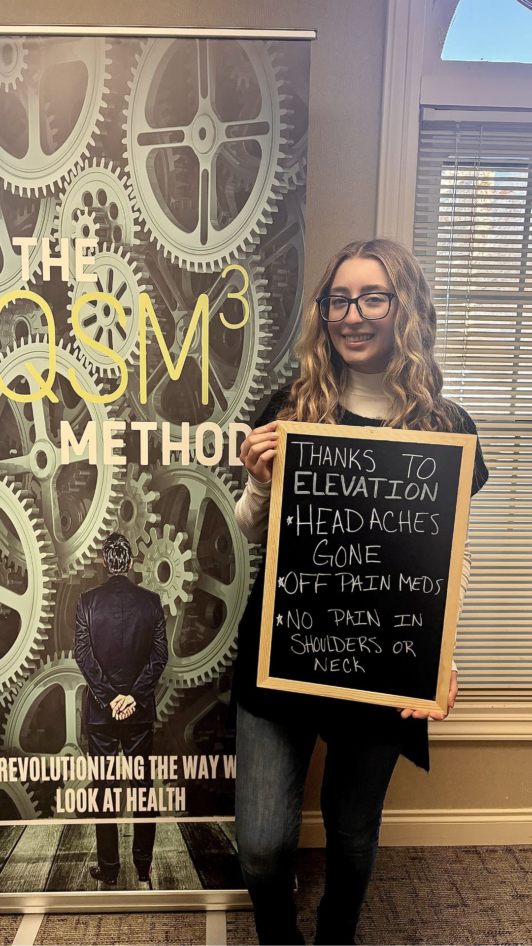 Patient holding sign: headaches gone, off pain meds, no pain in shoulders or neck