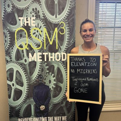 Patient holding sign: no migraines, tingling and numbness in arm gone